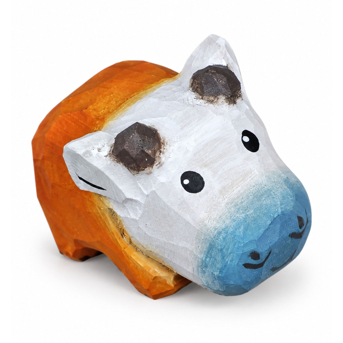 A hand-painted wooden cow figurine with a white face, blue nose, and orange body, shown on a clean white background.