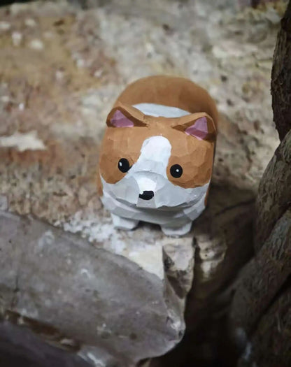 A low-poly geometric dog figurine with brown, white, and tan colors, standing on a textured stone surface.