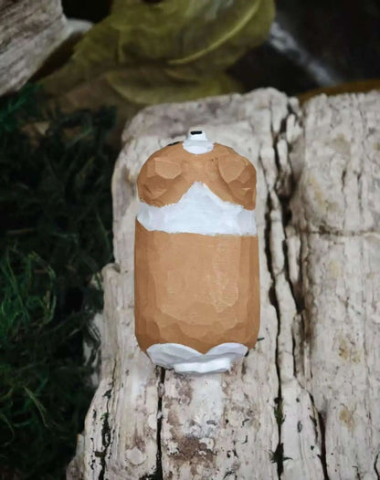 A low-poly 3D-printed torso-shaped object with brown and white sections, displayed on a textured white log with dark green moss in the background.