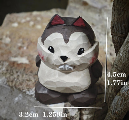 A hand-painted wooden tiger figurine with a smiling face, resting on a stone next to green moss and natural wood pieces.